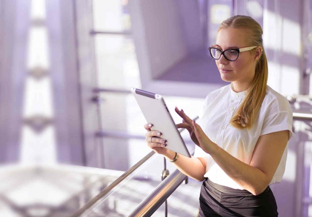 Women with glasses on tablet