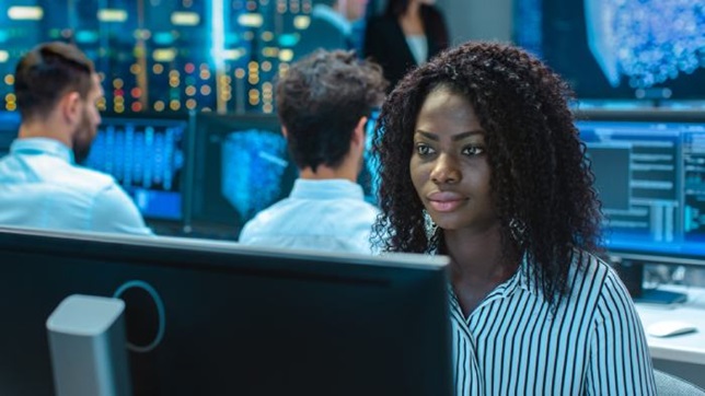 woman facing computer screen in lab